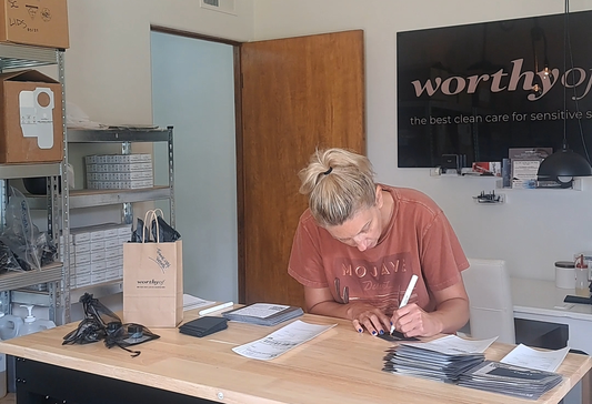 Founder packaging small-batch skincare orders with handwritten notes